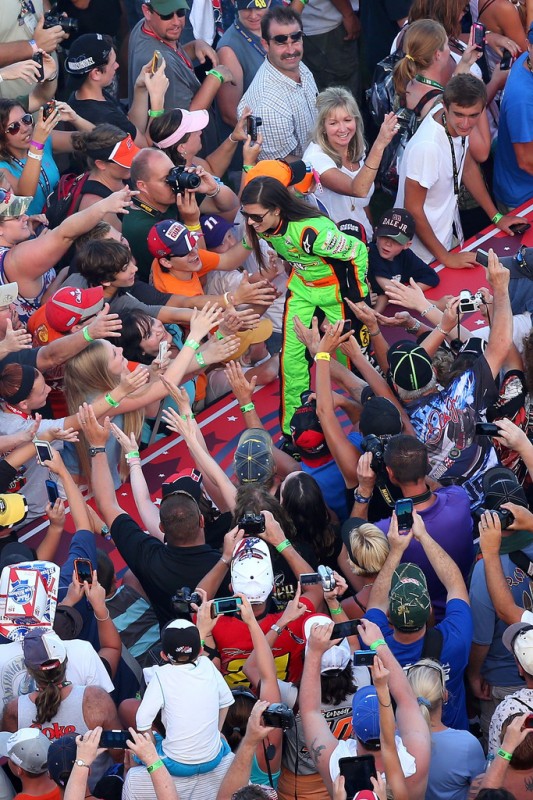 Danica Patrick, driver of the #10 GoDaddy.com Chevrolet, greets fans during driver introductions during the NASCAR Sprint Cup Series Coke Zero 400 at Daytona International Speedway on July 6, 2013 in Daytona Beach, Florida. 