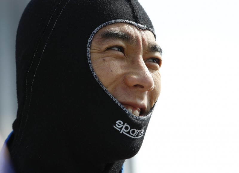Takuma Sato of Japan driver of the #14 ABC Supply A.J. Foyt Racing Honda talks to a crew member during practice for the Pocono INDYCAR 400 at Pocono Raceway on July 6, 2013 in Long Pond Pennsylvania. 