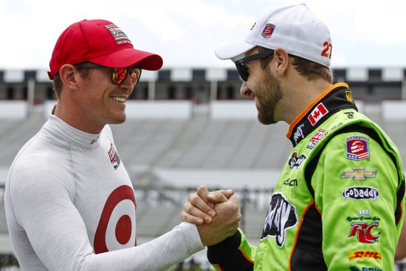 Scott Dixon of New Zealand, driver of the #9 Target Chip Ganassi Racing Honda talks to James Hinchcliffe of Canada, driver of the #27 GoDaddy Chevrolet during qualifying for the Pocono INDYCAR 400 at Pocono Raceway on July 6, 2013 in Long Pond, Penns