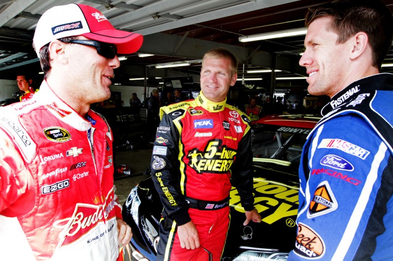 (L-R) Kevin Harvick, driver of the #29 Budweiser Chevrolet, talks with Clint Bowyer, driver of the #15 5-hour ENERGY Toyota, and Carl Edwards, driver of the #99 Fastenal Ford, during practice for the NASCAR Sprint Cup Series Camping World RV Sales 30