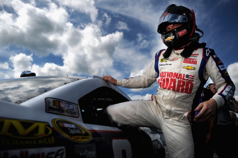 Dale Earnhardt Jr., driver of the #88 National Guard Chevrolet, climbs out of his car after qualifying for the NASCAR Sprint Cup Series Camping World RV Sales 301 at New Hampshire Motor Speedway on July 12, 2013 in Loudon, New Hampshire. 