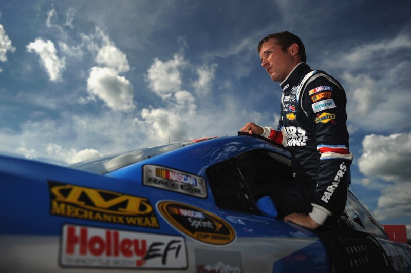Kasey Kahne, driver of the #5 Farmers Insurance Chevrolet, climbs out of his car after qualifying for the NASCAR Sprint Cup Series Camping World RV Sales 301 at New Hampshire Motor Speedway on July 12, 2013 in Loudon, New Hampshire. 