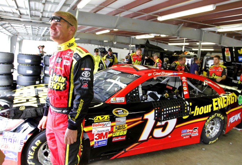 Clint Bowyer, driver of the #15 5-hour ENERGY Toyota, stands in the garage during practice for the NASCAR Sprint Cup Series Camping World RV Sales 301 at New Hampshire Motor Speedway on July 12, 2013 in Loudon, New Hampshire. 