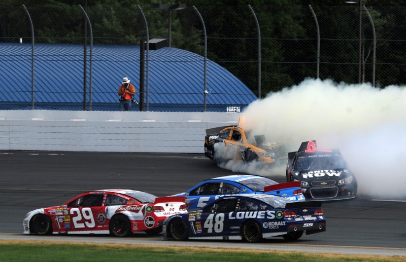 Ryan Newman, driver of the #39 Wix Filters Chevrolet, and Kurt Busch, driver of the #78 Furniture Row/Denver Mattress Chevrolet, spin out during the NASCAR Sprint Cup Series Camping World RV Sales 301 at New Hampshire Motor Speedway on July 14, 2013 in Loudon, New Hampshire. 