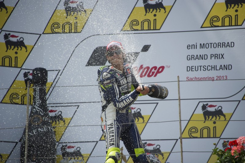 Valentino Rossi of Italy and Yamaha Factory Racing celebrates on the podiun the third place and sprays champagne at the end of the MotoGP race during the MotoGp of Germany - Race at Sachsenring Circuit on July 14, 2013 in Hohenstein-Ernstthal, Germany. 