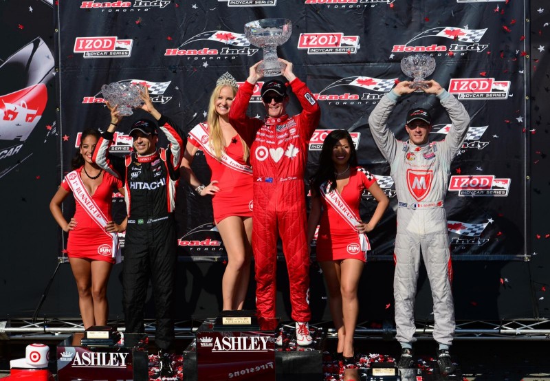 (L-R) Second place finisher Helio Castroneves of Brazil driver of the #3 Team Penske Chevrolet Dallara, Scott Dixon of New Zealand driver of the #9 Target Chip Ganassi Racing Honda Dallara and Sebastien Bourdais of France driver of the #7 Dragon Racing Chevrolet Dallara on the podium after race #2 of the IZOD IndyCar Series Honda Indy Toronto on July 14, 2013 in the streets of Toronto, Ontario, Canada.