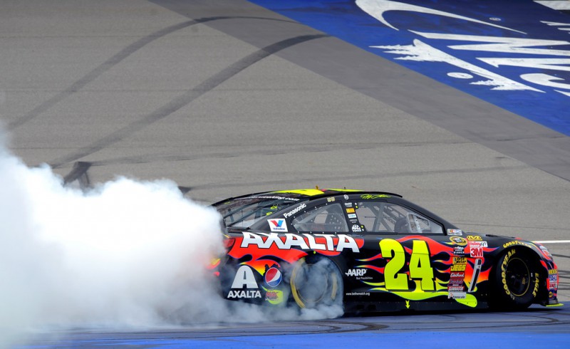Jeff Gordon, driver of the #24 Axalta Chevrolet, celebrates with a burnout after winning the NASCAR Sprint Cup Series Pure Michigan 400 at Michigan International Speedway on August 17, 2014 in Brooklyn, Michigan. 