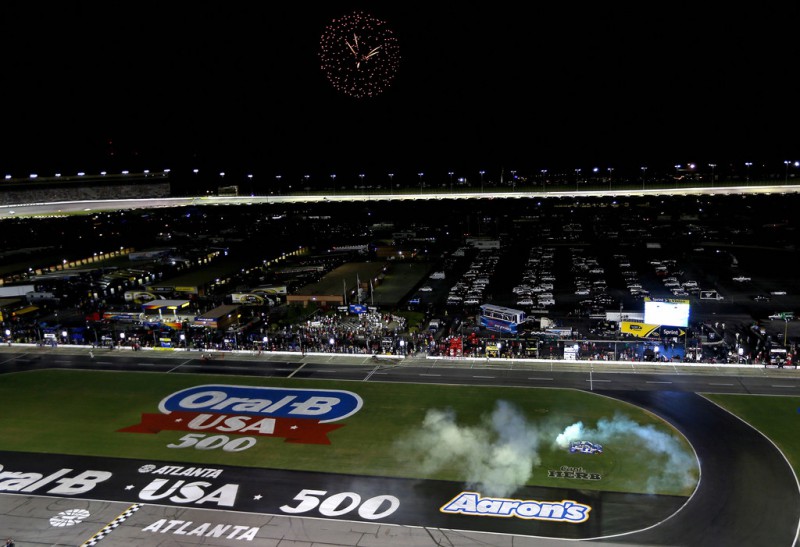 Kasey Kahne, driver of the #5 Farmers Insurance Chevrolet, celebrates with a burnout after winning the NASCAR Sprint Cup Series Oral-B USA 500 at Atlanta Motor Speedway on August 31, 2014 in Hampton, Georgia. 