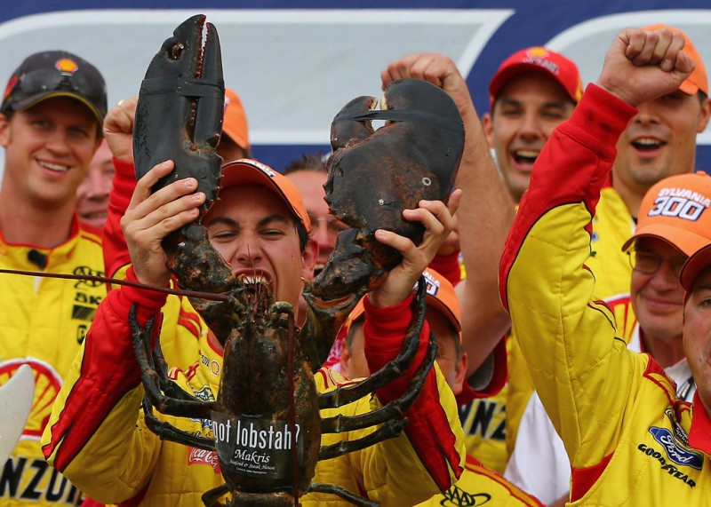 Joey Logano, driver of the #22 Shell-Pennzoil Ford, receives a lobster in victory lane after winning the NASCAR Sprint Cup Series Sylvania 300 at New Hampshire Motor Speedway on September 21, 2014 in Loudon, New Hampshire. 