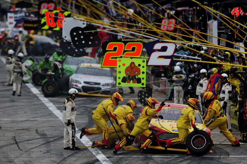 Joey Logano, driver of the #22 Shell-Pennzoil Ford, makes a pit stop during the NASCAR Sprint Cup Series Sylvania 300 at New Hampshire Motor Speedway on September 21, 2014 in Loudon, New Hampshire. 