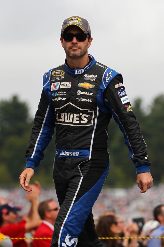 Jimmie Johnson, driver of the #48 Lowe's Chevrolet, walks on the grid during the NASCAR Sprint Cup Series Sylvania 300 at New Hampshire Motor Speedway on September 21, 2014 in Loudon, New Hampshire. 