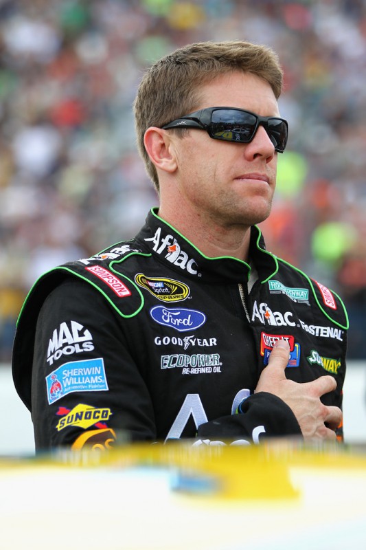 Carl Edwards, driver of the #99 Aflac Ford, stands for the national anthem during the NASCAR Sprint Cup Series Sylvania 300 at New Hampshire Motor Speedway on September 21, 2014 in Loudon, New Hampshire. 