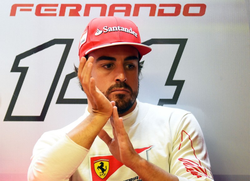 Fernando Alonso of Spain and Ferrari looks on in the garage during final practice ahead of the Singapore Formula One Grand Prix at Marina Bay Street on September 20, 2014 in Singapore, Singapore. 