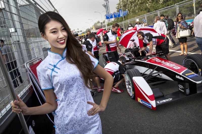 A pit girl stands next to a team car on the grid before the inaugral FIA Formula E Beijing ePrix Championship race on September 13, 2014 in Beijing, China. The electric car racing series is backed by many of the major sponsors of the main Formula One circuit, and is set to be hosted in nine other cities worldwide. 
