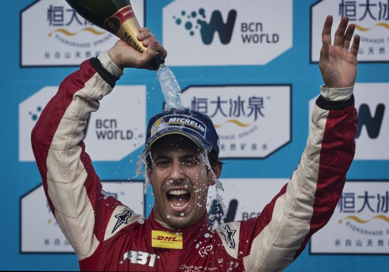 Audi Sport ABT driver Lucas di Grassi of Brazil celebrates on the podium after winning the inaugral FIA Formula E Bejing ePrix Championship race on September 13, 2014 in Beijing, China. The electric car racing series is set to be hosted in nine other cities worldwide. 