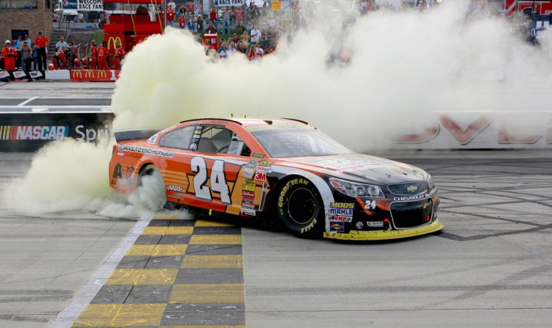 Jeff Gordon, driver of the #24 Drive To End Hunger Chevrolet, celebrates with a burnout after winning the NASCAR Sprint Cup Series AAA 400 at Dover International Speedway on September 28, 2014 in Dover, Delaware. 