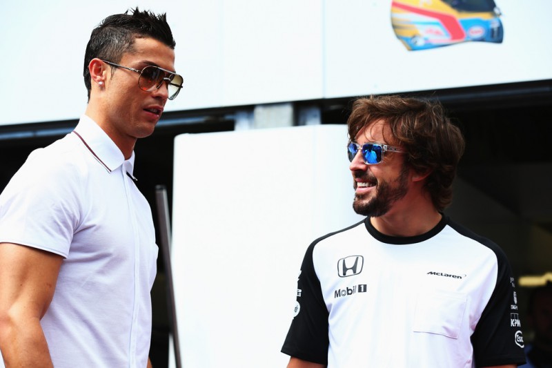 Real Madrid footballer Cristiano Ronaldo meets Fernando Alonso of Spain and McLaren Honda in the pitlane before the Monaco Formula One Grand Prix at Circuit de Monaco on May 24, 2015 in Monte-Carlo, Monaco.