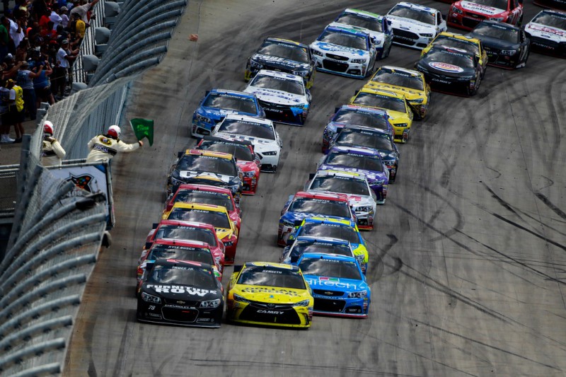 Martin Truex Jr., driver of the #78 Furniture Row/Visser Precision Chevrolet, and Matt Kenseth, driver of the #20 Dollar General Toyota, lead the field to a restart during the NASCAR Sprint Cup Series FedEx 400 Benefiting Autism Speaks at Dover International Speedway on May 31, 2015 in Dover, Delaware.