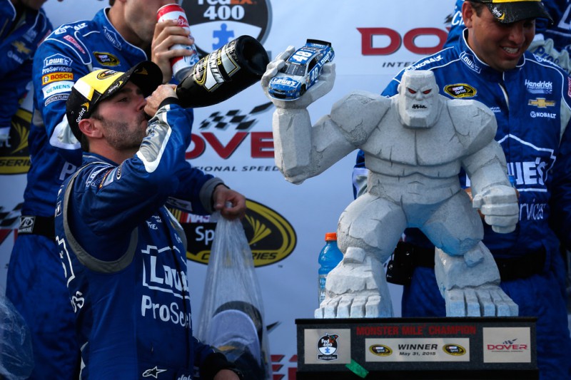 Jimmie Johnson, driver of the #48 Lowe's Pro Services Chevrolet, celebrates with champagne and the Miles the Monster trophy in Victory Lane after winning the NASCAR Sprint Cup Series FedEx 400 Benefiting Autism Speaks at Dover International Speedway on May 31, 2015 in Dover, Delaware. 