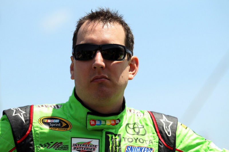 Kyle Busch, driver of the #18 M&M's Crispy Toyota, takes part in pre-race ceremonies for the NASCAR Sprint Cup Series Axalta 'We Paint Winners' 400 at Pocono Raceway on June 7, 2015 in Long Pond, Pennsylvania.