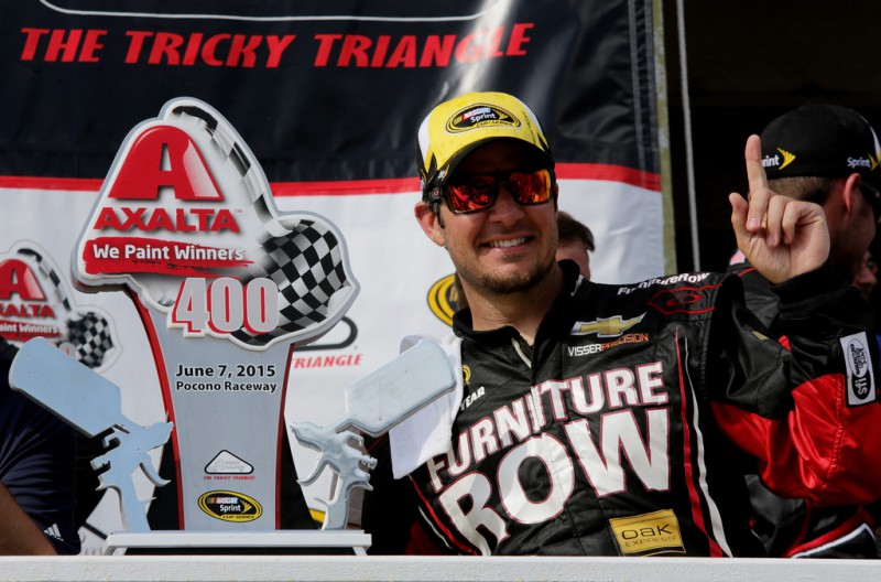 Martin Truex Jr., driver of the #78 Furniture Row/Visser Precision Chevrolet, celebrates in Victory Lane after winning the NASCAR Sprint Cup Series Axalta 'We Paint Winners' 400 at Pocono Raceway on June 7, 2015 in Long Pond, Pennsylvania. 