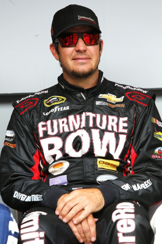 Martin Truex Jr., driver of the #78 Furniture Row/Visser Precision Chevrolet, waits for the introductions prior to the NASCAR Sprint Cup Series Quicken Loans 400 at Michigan International Speedway on June 14, 2015 in Brooklyn, Michigan. 