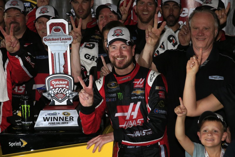 Kurt Busch, driver of the #41 Haas Automation Chevrolet, Gene Haas, co-owner of Stewart Haas Racing, and his team pose in an alternate Victory Lane after winning the NASCAR Sprint Cup Series Quicken Loans 400 at Michigan International Speedway on June 14, 2015 in Brooklyn, Michigan. 