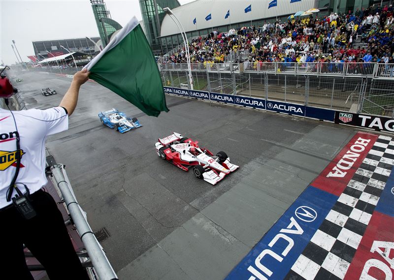 Simon Pagenaud leads Juan Pablo Montoya as they race past the start line during the Honda Toronto IndyCar race in Toronto on Sunday, June 14, 2015.