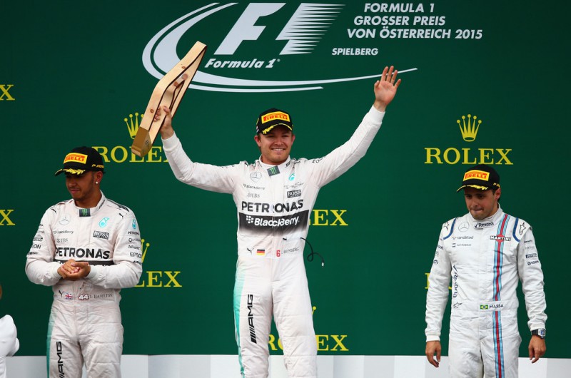 Nico Rosberg of Germany and Mercedes GP lifts the trophy on the podium next to Lewis Hamilton of Great Britain and Mercedes GP and Felipe Massa of Brazil and Williams after winning the Formula One Grand Prix of Austria at Red Bull Ring on June 21, 2015 in Spielberg, Austria. 