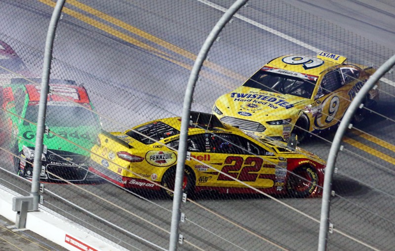 Danica Patrick, driver of the #10 GoDaddy Chevrolet, Joey Logano, driver of the #22 Shell Pennzoil Ford, and Sam Hornish Jr., driver of the #9 Twisted Tea Ford, are involved in an incident during the NASCAR Sprint Cup Series Coke Zero 400 Powered by Coca-Cola at Daytona International Speedway on July 5, 2015 in Daytona Beach, Florida. 