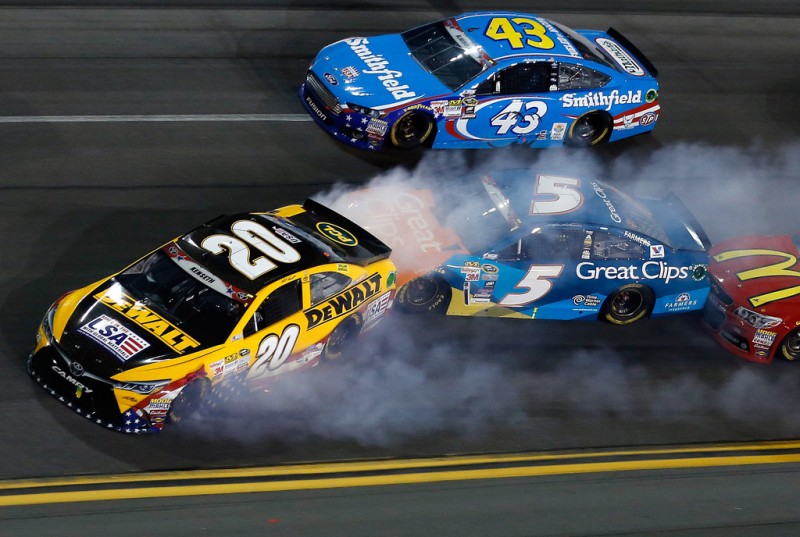 Matt Kenseth, driver of the #20 DeWalt Made in USA Toyota, and Kasey Kahne, driver of the #5 Great Clips/Shark Week Chevrolet, are involved in an on-track incident during the NASCAR Sprint Cup Series Coke Zero 400 Powered by Coca-Cola at Daytona International Speedway on July 6, 2015 in Daytona Beach, Florida. 