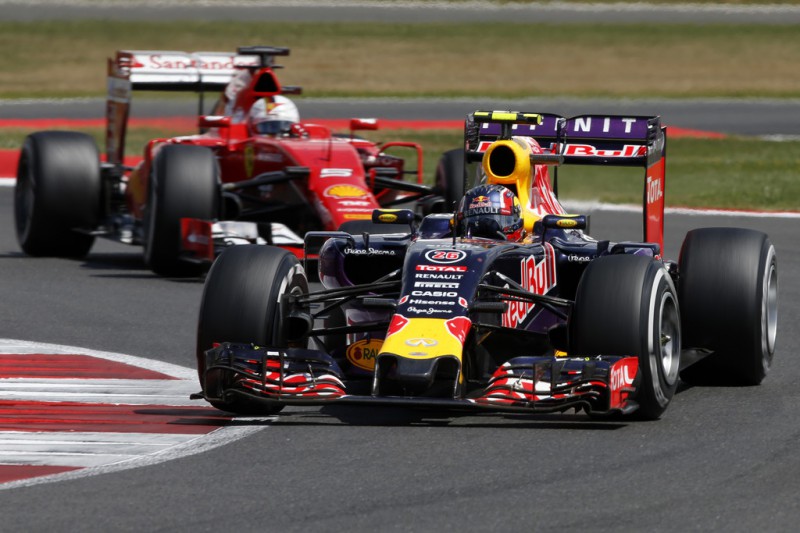 Daniil Kvyat of Russia and Infiniti Red Bull Racing drives ahead of Sebastian Vettel of Germany and Ferrari during the Formula One Grand Prix of Great Britain at Silverstone Circuit on July 5, 2015 in Northampton, England. 