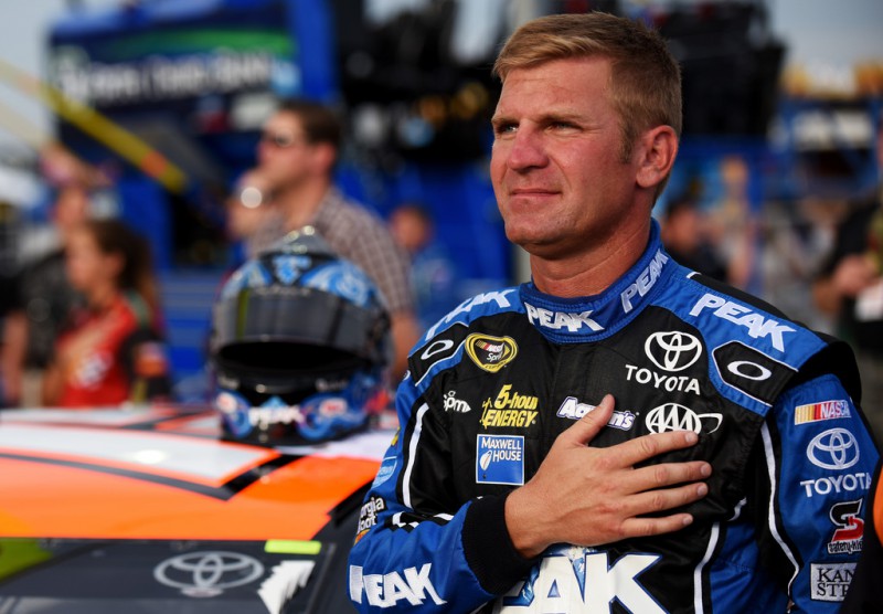 Clint Bowyer, driver of the #15 Hughes General Contractors/Casey's Toyota, takes part in pre-race ceremonies for the NASCAR Sprint Cup Series Quaker State 400 presented by Advance Auto Parts at Kentucky Speedway on July 11, 2015 in Sparta, Kentucky. Clint Bowyer, driver of the #15 Hughes General Contractors/Casey's Toyota, takes part in pre-race ceremonies for the NASCAR Sprint Cup Series Quaker State 400 presented by Advance Auto Parts at Kentucky Speedway on July 11, 2015 in Sparta, Kentucky.