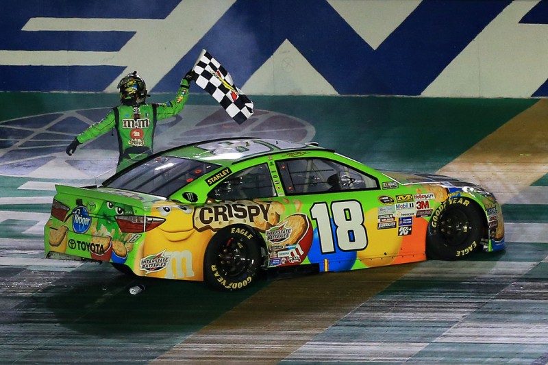 Kyle Busch, driver of the #18 M&M's Crispy Toyota, celebrates with the checkered flag after winning the NASCAR Sprint Cup Series Quaker State 400 presented by Advance Auto Parts at Kentucky Speedway on July 11, 2015 in Sparta, Kentucky. 