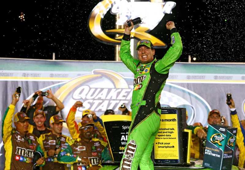 Kyle Busch, driver of the #18 M&M's Crispy Toyota, celebrates in Victory Lane after winning the NASCAR Sprint Cup Series Quaker State 400 presented by Advance Auto Parts at Kentucky Speedway on July 11, 2015 in Sparta, Kentucky. 