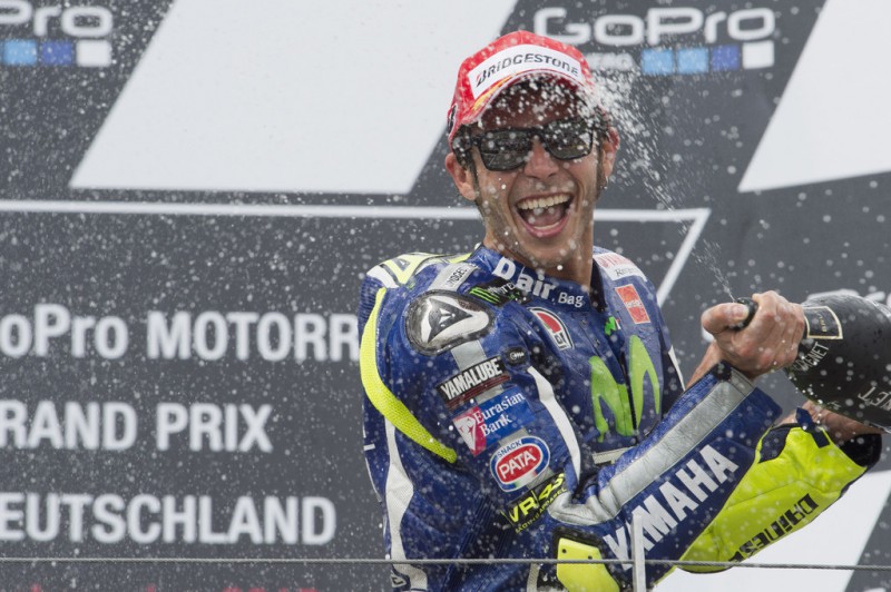 Valentino Rossi of Italy and Movistar Yamaha MotoGP celebrates the third place on the podium at the end of the MotoGP race during the MotoGp of Germany - Race at Sachsenring Circuit on July 12, 2015 in Hohenstein-Ernstthal, Germany. Valentino Rossi of Italy and Movistar Yamaha MotoGP celebrates the third place on the podium at the end of the MotoGP race during the MotoGp of Germany - Race at Sachsenring Circuit on July 12, 2015 in Hohenstein-Ernstthal, Germany.