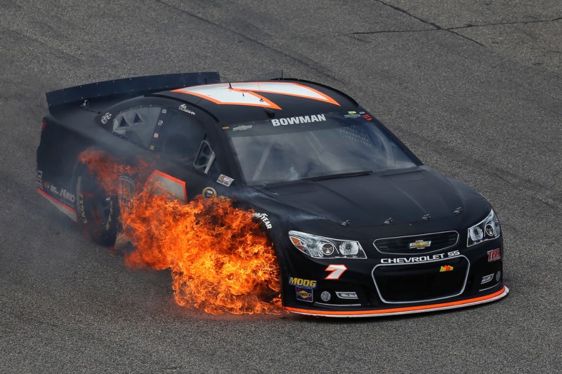 Alex Bowman drives the #7 Tommy Baldwin Racing Chevrolet off of pit road as his car catches fire during the NASCAR Sprint Cup Series 5-Hour ENERGY 301 at New Hampshire Motor Speedway on July 19, 2015 in Loudon, New Hampshire. Alex Bowman drives the #7 Tommy Baldwin Racing Chevrolet off of pit road as his car catches fire during the NASCAR Sprint Cup Series 5-Hour ENERGY 301 at New Hampshire Motor Speedway on July 19, 2015 in Loudon, New Hampshire.