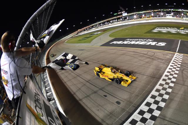 Ryan Hunter-Reay takes the twin checkers to win the Iowa Corn 300 at Iowa Speedway.
