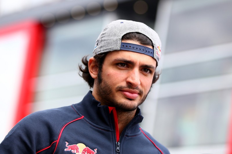 Carlos Sainz of Spain and Scuderia Toro Rosso walks in the paddock before the Formula One Grand Prix of Hungary at Hungaroring on July 26, 2015 in Budapest, Hungary. Carlos Sainz of Spain and Scuderia Toro Rosso walks in the paddock before the Formula One Grand Prix of Hungary at Hungaroring on July 26, 2015 in Budapest, Hungary.