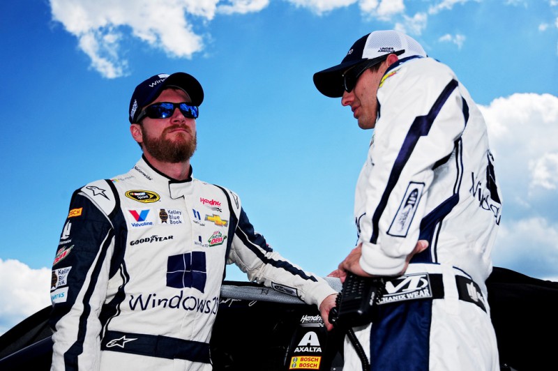 Dale Earnhardt Jr., driver of the #88 Microsoft Chevrolet, talks with crew chief Greg Ives on the grid prior to the NASCAR Sprint Cup Series Windows 10 400 at Pocono Raceway on August 2, 2015 in Long Pond, Pennsylvania. 