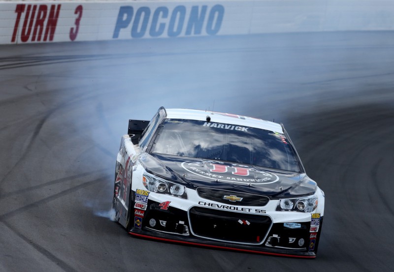 Smoke pours from the Kevin Harvick, driver of the #4 Jimmy John's/Budweiser Chevrolet, during the NASCAR Sprint Cup Series Windows 10 400 at Pocono Raceway on August 2, 2015 in Long Pond, Pennsylvania. 