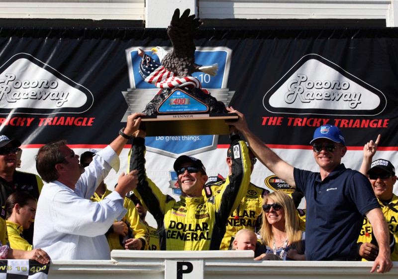 Matt Kenseth, driver of the #20 Dollar General Toyota, celebrates with the trophy in Victory Lane after winning the NASCAR Sprint Cup Series Windows 10 400 at Pocono Raceway on August 2, 2015 in Long Pond, Pennsylvania. 