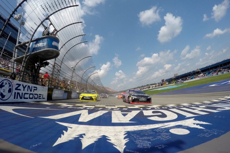 Matt Kenseth, driver of the #20 Dollar General Toyota, and Denny Hamlin, driver of the #11 FedEx Freight Toyota, lead the field during parade laps before the NASCAR Sprint Cup Series Pure Michigan 400 at Michigan International Speedway on August 16, 2015 in Brooklyn, Michigan. 