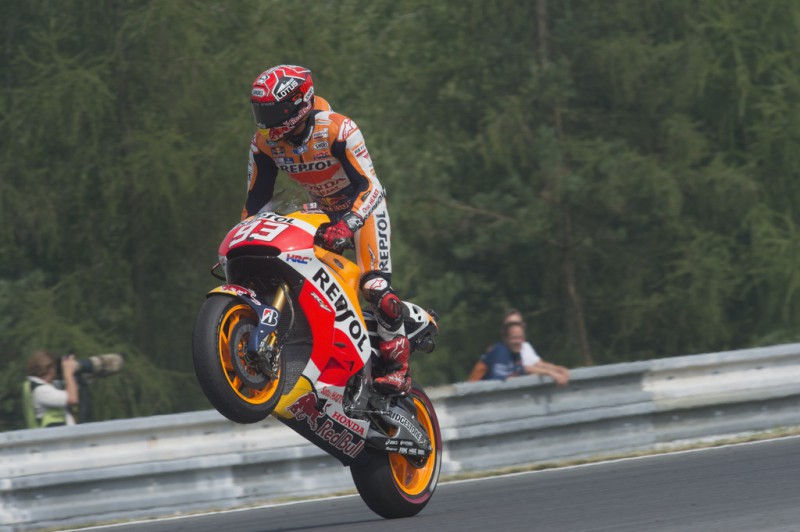 Marc Marquez of Spain and Repsol Honda Team lifts the front wheel and celebrates the second place at the end of the MotoGP race during the MotoGp of Czech Republic - Race at Brno Circuit on August 16, 2015 in Brno, Czech Republic. Marc Marquez of Spain and Repsol Honda Team lifts the front wheel and celebrates the second place at the end of the MotoGP race during the MotoGp of Czech Republic - Race at Brno Circuit on August 16, 2015 in Brno, Czech Republic.