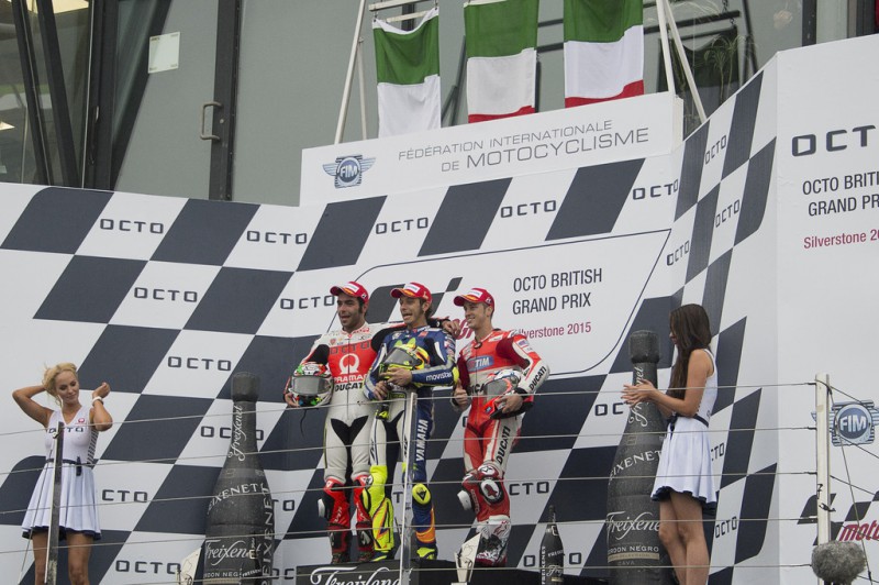 (L-R) Danilo Petrucci of Italy and Pramac Racing, Valentino Rossi of Italy and Movistar Yamaha MotoGP, Andrea Dovizioso of Italy and Ducati Team pose on the podium at the end of the MotoGP race during the MotoGp Of Great Britain - Race at Silverstone Circuit on August 30, 2015 in Northampton, United Kingdom. 