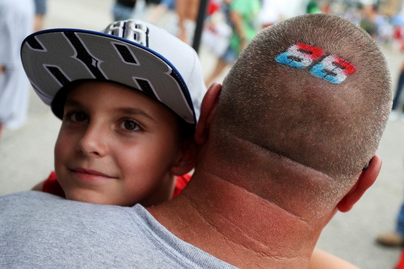 A young NASCAR fan and his father take in pre-race festivities for the NASCAR Sprint Cup Series Bojangles' Southern 500 at Darlington Raceway on September 6, 2015 in Darlington, South Carolina. A young NASCAR fan and his father take in pre-race festivities for the NASCAR Sprint Cup Series Bojangles' Southern 500 at Darlington Raceway on September 6, 2015 in Darlington, South Carolina.