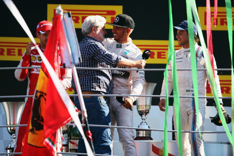 Lewis Hamilton of Great Britain and Mercedes GP hugs film director George Lucas on the podium after winning the Formula One Grand Prix of Italy at Autodromo di Monza on September 6, 2015 in Monza, Italy. Lewis Hamilton of Great Britain and Mercedes GP hugs film director George Lucas on the podium after winning the Formula One Grand Prix of Italy at Autodromo di Monza on September 6, 2015 in Monza, Italy.