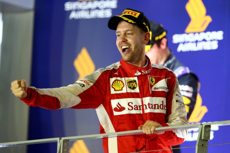 Sebastian Vettel of Germany and Ferrari celebrates on the podium after winning the Formula One Grand Prix of Singapore at Marina Bay Street Circuit on September 20, 2015 in Singapore. Sebastian Vettel of Germany and Ferrari celebrates on the podium after winning the Formula One Grand Prix of Singapore at Marina Bay Street Circuit on September 20, 2015 in Singapore.