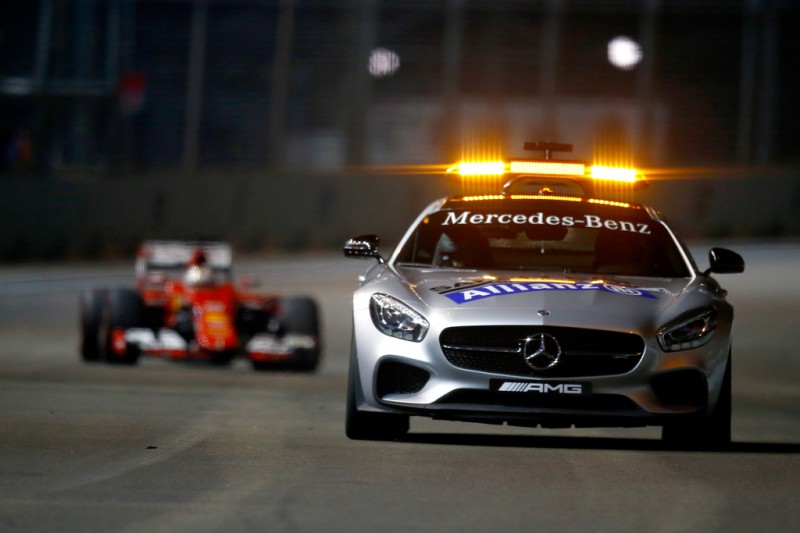 The safety car drives ahead of Sebastian Vettel of Germany and Ferrari during the Formula One Grand Prix of Singapore at Marina Bay Street Circuit on September 20, 2015 in Singapore. The safety car drives ahead of Sebastian Vettel of Germany and Ferrari during the Formula One Grand Prix of Singapore at Marina Bay Street Circuit on September 20, 2015 in Singapore.