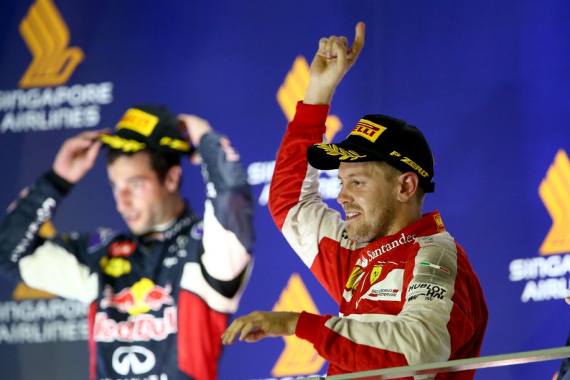 Sebastian Vettel of Germany and Ferrari celebrates on the podium after winning the Formula One Grand Prix of Singapore at Marina Bay Street Circuit on September 20, 2015 in Singapore. Sebastian Vettel of Germany and Ferrari celebrates on the podium after winning the Formula One Grand Prix of Singapore at Marina Bay Street Circuit on September 20, 2015 in Singapore.